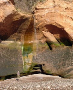 A small waterfall splattering on the beach at the Five Islands Provincial Park